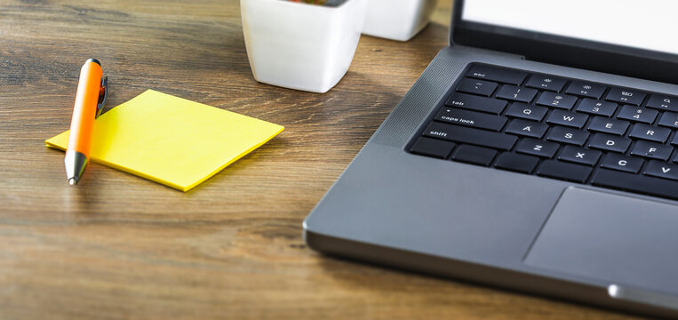 Yellow sticky note with laptop office desk