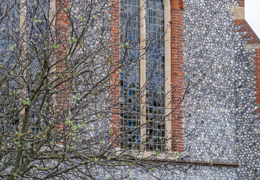 Tree in front of stained glass windows of an Anglo Saxon Church