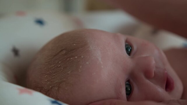 Parent gently combs newborn baby hair during bath time with cute bear shaped comb promoting hygiene comfort care and bonding. Infant child family love parenthood cozy home adorable childhood innocence