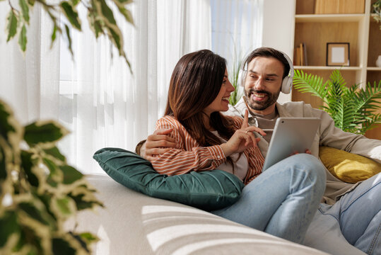 Couple enjoys time together while using a tablet at home