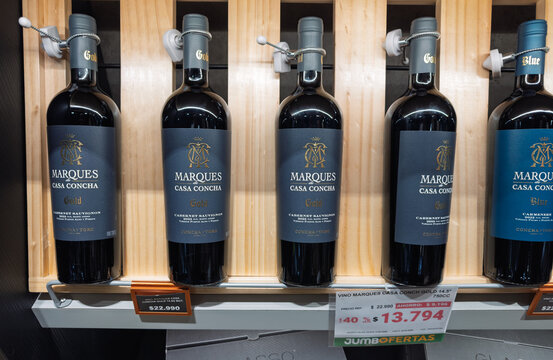 Santiago, Chile, March 09, 2026, Marques de Casa Concha, glass bottle, 0,75 l, bottles of Cabernet Sauvignon Gold and Carmenere Blue wine on a wooden display shelf in a supermarket