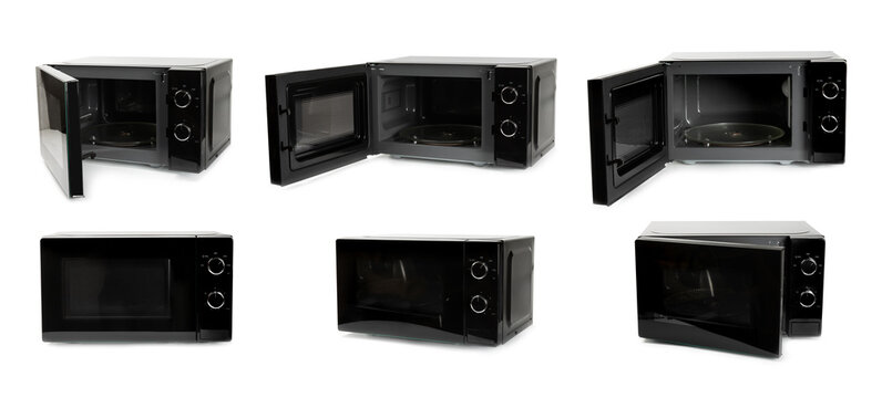 Modern black microwave isolated on white background. Using microwave everyday in the kitchen. The concept of cooking. Microwave oven in modern kitchen interior 