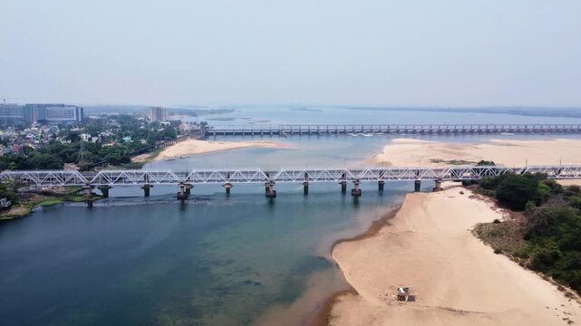 Aerial View of Railway Truss Bridge and Jobra Barrage on Mahanadi River Cuttack Odisha in 4K. Indian Railway Bridge and Water Control Barrage over Mahanadi Odisha. 