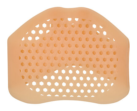 A beige silicone shoe liner on an isolated background featuring a perforated honeycomb structure for ventilation and forefoot cushioning