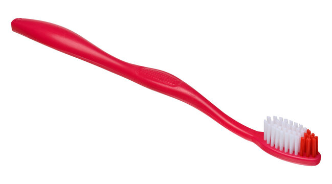 Plastic red toothbrush on isolated background, close up