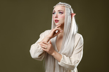 Naklejka premium Beautiful elf girl on dark olive background