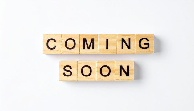 Text COMING SOON spelled with wooden cubes, square wood blocks, product launch announcement concept, anticipation and upcoming release