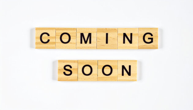 Text COMING SOON spelled with wooden cubes, square wood blocks, product launch announcement concept, anticipation and upcoming release