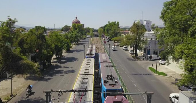 Tren ligero recorriendo avenida urbana en Guadalajara con vista a&eacute;rea