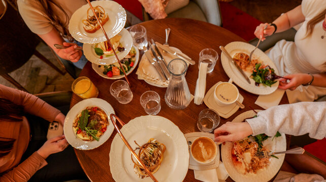 Friends enjoying a delicious meal together at a cozy restaurant table