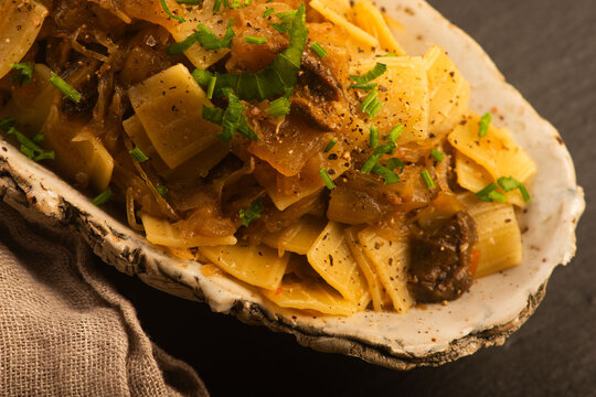 Quadretti Pasta with Sauerkraut and Wild Mushrooms on Handmade Ceramic Plate