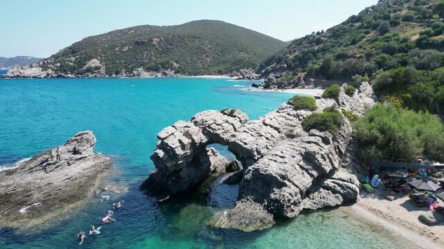 Aerial view of Likodimos beach with natural stone arch in Greece