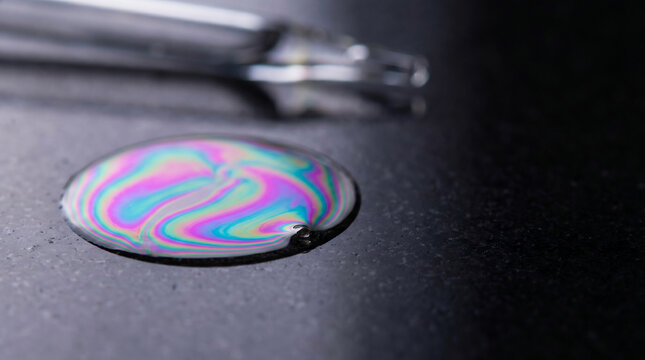 Mineral Oil Droplet Spreading into Thin-Film Interference Colors &ndash; Oil Slick Macro &ndash; Iridescent Fluid Dynamics &ndash; Cross-Polarized Studio Light
