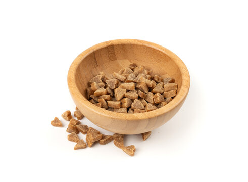 Mini pet food shaped like hearts isolated, small dogs crunchy treats pile, flavored brown dry kibble