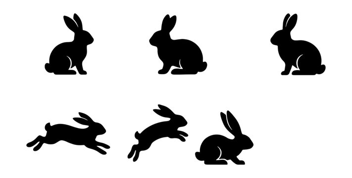 Set of black silhouettes of rabbits in different poses