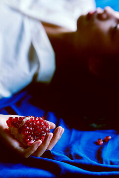 Closeup of the girl holding a pomegranate