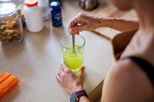 Woman prepares liquid supplement
