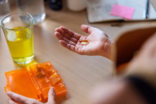 Taking daily vitamins from pill organizer