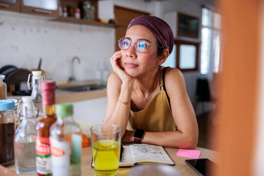 Woman with headscarf daydreaming