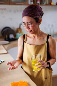 Woman taking prescription with flavored water
