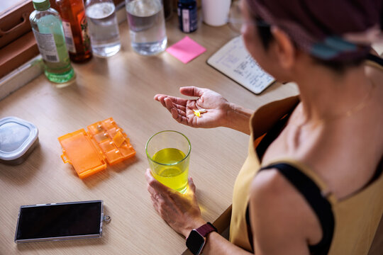 Woman taking daily medication at home