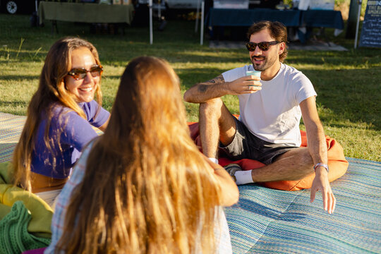 Friends Relaxing and Drinking Coffee at Farmers Market 