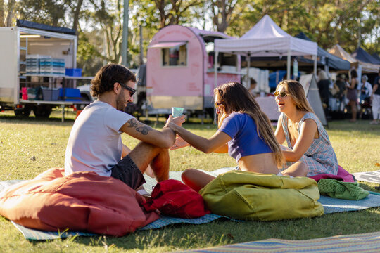 Friends Laughing and Drinking Coffee at Farmers Market in Australia