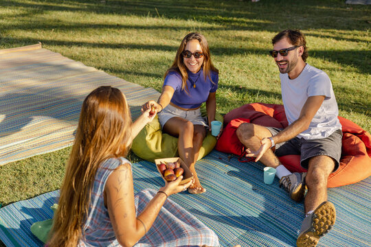Friends Sharing Fresh Figs at Farmers Market in Byron Bay, Australia