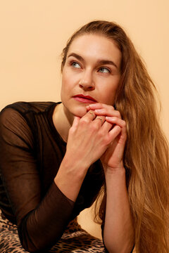 Woman With Long Hair Sits Thoughtful 
