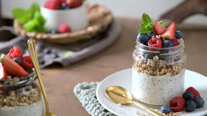 Overnight Chia Seed Pudding with Fresh Berries and Granola in a Glass Jar © homydesign
