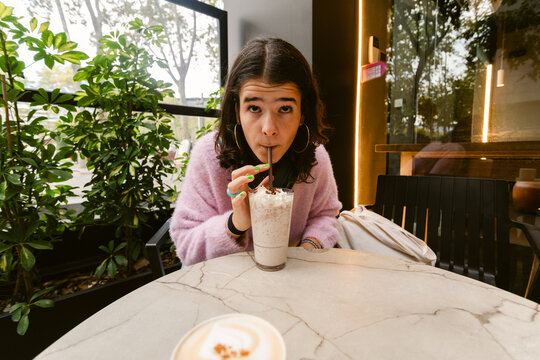 Sipping Drink at Cafe