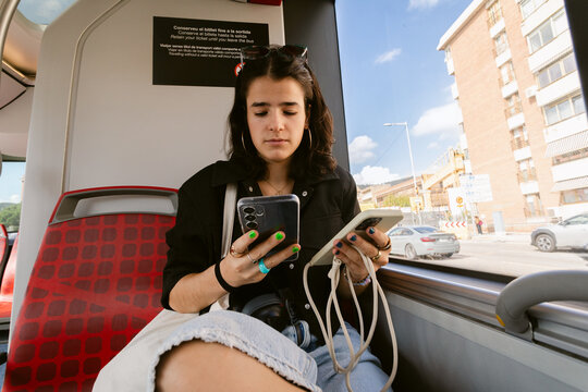 Using Two Phones Sitting City Bus