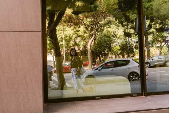 Standing by Window Urban Reflection