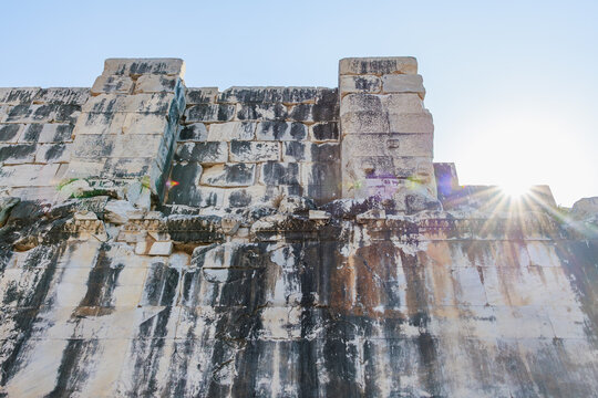 Ancient stone wall with sunlight on historic ruins