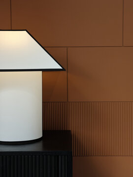 Still life decor of a table lamp and brown wall