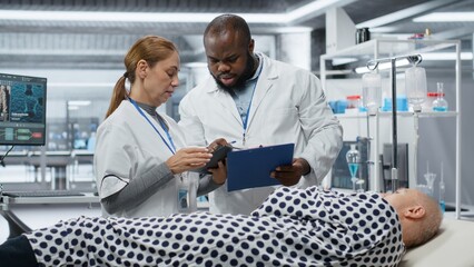 Obraz premium Medical team conducting observation and testing of a patient during a new drug trial, gathering pharmacology analysis and treatment outcome. Healthcare breakthrough in medicine. Camera B.