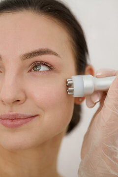Woman receiving microcurrent facial treatment
