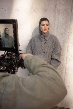 Photographer Filming Fashion Model on City Street