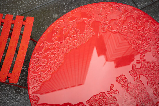 Rain Covered Red Table with City Reflection in New York