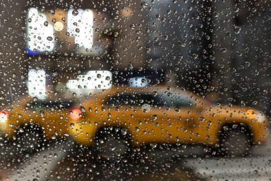 Rainy Window with Yellow Taxi in New York City