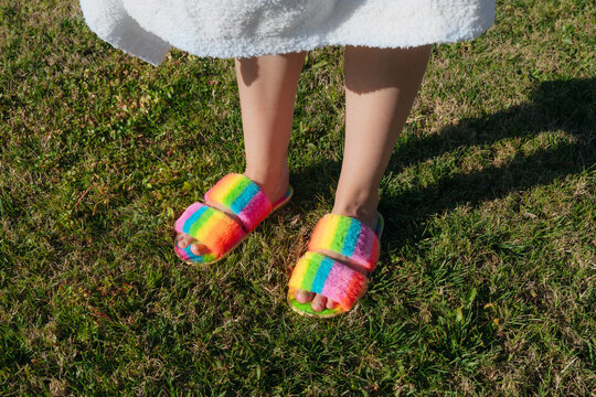 Brightly Colored Slippers on Grass in a Sunny Outdoor Area