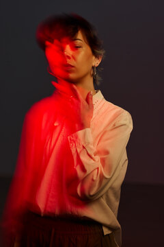 Model poses with red light effect during photo session