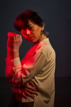 Woman in red light with motion blur, evening shoot