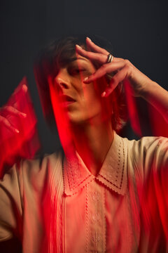 Creative expression with red light and hands in studio setting