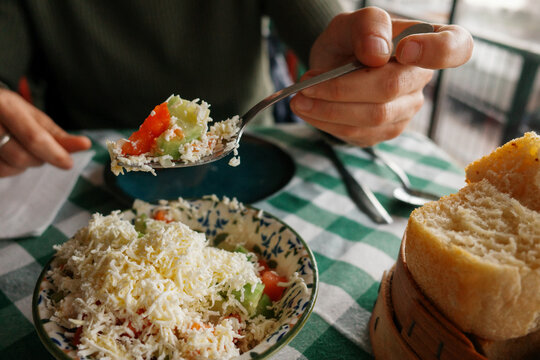 Enjoying Greek Salad and Bread at a Cafe