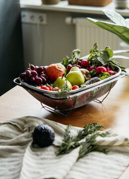 Big tray with different fresh fruits and vegetables on the table. Harvest and healthy organic food concept.