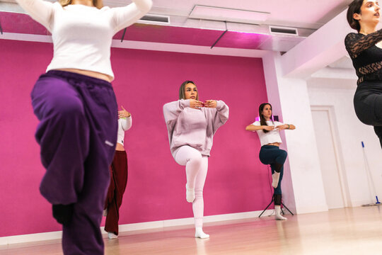 Women practicing dance positions in studio class