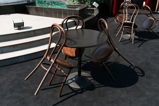 Chairs Stacked on a Round Table at an Outdoor Event Venue