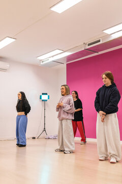 Young women standing ready to start dance class