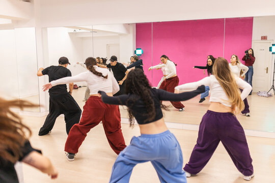 Group of young dancers practicing urban choreography in studio
